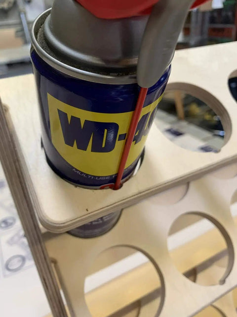 US Made Spray Can Lube Holder And 24 Slot Storage Rack Wood Shelf Organizer Case with WD-40 can in garage setting.