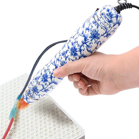 Hand using Dope Resin Heat Gun 300W With 6.6Ft Cable For Crafts And DIY Projects, Multi Purpose Electric Heating Nozzle on surface