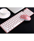 Top Tier Wireless Mechanical Gaming Keyboard Featuring Quiet Mute Switch Laser Etched Markings And Extended Battery Life For Rapid Typing And All Day Play next to a cup and laptop.