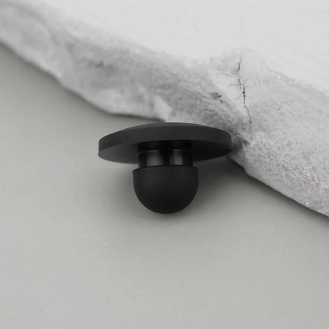 Close-up of a single black rubber foot push in knurled bumper for 1/4 inch holes, part of 100x Rubber Feet Push In Knurled Bumpers For 1/4 Inch Holes, No Tools Needed Press Fit, No Mess Snap In For Furniture Cabinets Electronics Enclosures And DIY Projects, Protect Floors, Reduce Vibration, Durable Non Slip Bumpers.