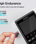 Hand holding Industrial Grade 256GB MicroSD Card With Adapter for dash cams, displaying read and write speeds, near a dash camera.