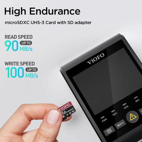 Hand holding Industrial Grade 256GB MicroSD Card With Adapter for dash cams, displaying read and write speeds, near a dash camera.