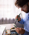 Person using soldering iron with Six Piece Soldering Tips Set For ST Series Irons ST7 WLC100 SP40L WP35 on circuit board