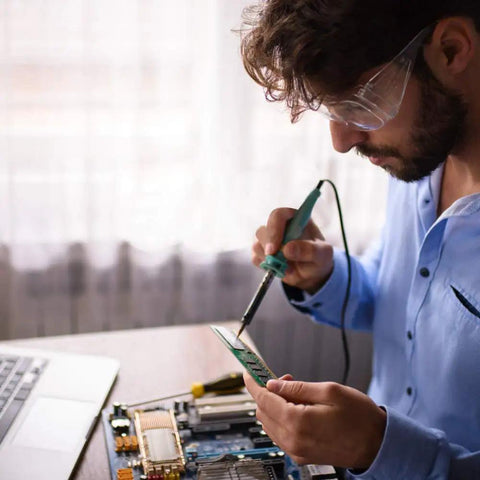 Person using soldering iron with Six Piece Soldering Tips Set For ST Series Irons ST7 WLC100 SP40L WP35 on circuit board