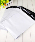 White Plastic Mailing Bags Pack Heavy Duty Self Seal Envelopes Lightweight Yet Thick And Durable Weatherproof For Clothes Shipping A Real Workhorse For Couriers And Online Sellers displayed on a wooden surface