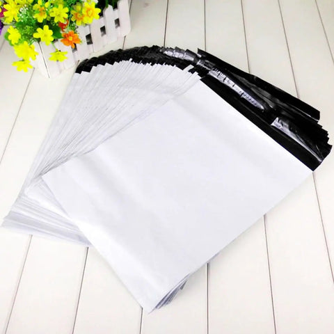 White Plastic Mailing Bags Pack Heavy Duty Self Seal Envelopes Lightweight Yet Thick And Durable Weatherproof For Clothes Shipping A Real Workhorse For Couriers And Online Sellers displayed on a wooden surface