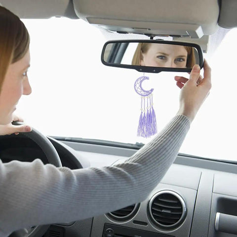 Woman hanging purple moon ornament from DIY Dream Catcher Kit For Beginners 24 Piece Colorful Mini Ornament Making Set on car mirror