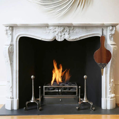 Large Wood Fire Bellows With Hanging Strap Cast Nozzle For Outdoor Camping And BBQ Grill Chimney Hand Pump Fireplace Tool Accessories Premium Leather Heat Resistant Durable Solid Wood Construction hanging by a white fireplace.