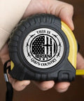 Solid Build Personalized Tape Measure For Woodworking And DIY Projects Featuring This Is Gods Country Engraving in hand.