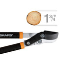 Go-To 28-Inch Power-Lever Bypass Lopper For Tree Trimming slicing through 1.75-inch branch, sharp precision-ground steel blade visible.