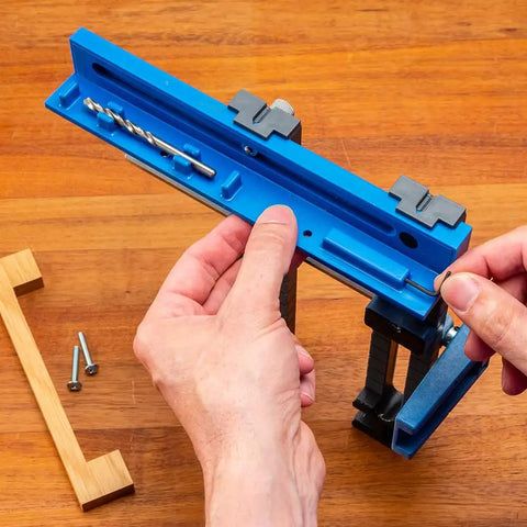 Hands adjusting Cabinet Hardware Jig And Pull Drill Guide Pro For Easy Install, Knob And Handle Hole Locator on a wooden surface.