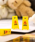 Ultimate Boss Set Of 12 Mini Wet Floor Signs Rad Tiny Yellow Caution Sign For Safety Fun And Doll Play With Durable Plastic Warning Tags Game Changer Value shown with three mini caution signs on a tabletop.