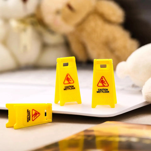 Ultimate Boss Set Of 12 Mini Wet Floor Signs Rad Tiny Yellow Caution Sign For Safety Fun And Doll Play With Durable Plastic Warning Tags Game Changer Value shown with three mini caution signs on a tabletop.