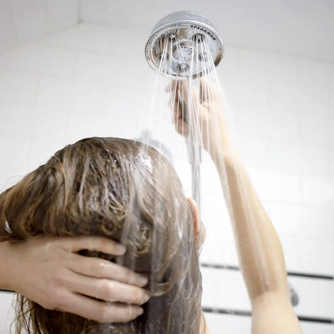 Person using Premium Handheld Shower Head With AnyStream 360° Technology, adjustable spray setting for a solid, relaxing shower.