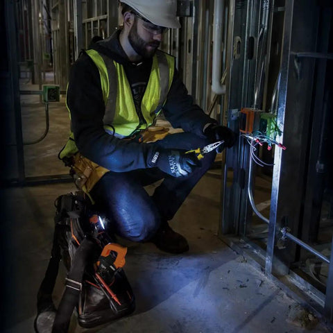 Electrician using Digital Clamp Meter With Autorange TRMS For Electricians, Measures AC Current, AC And DC Voltage on a circuit.