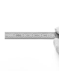 Dead Nuts Accurate Six Inch Metal Ruler Featuring Sharp Etched Scale Markings Built From Fully Hardened Carbon Steel With Sleek Chrome Plating held in a gloved hand.