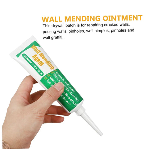 Hand holding tube of Wall Repair Paste Set With Self Adhesive Mending Cream, Scraper And Spout For Quick Crack Fix