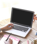 Person using Game Changing Graphics Drawing Tablet With 8192 Pressure Levels And A Dope Battery Free Pen at a laptop on a wooden desk.