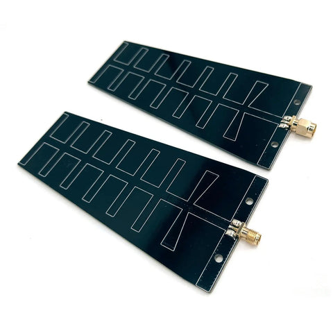 Two black 12dBi 2.4GHz high-gain WiFi directional Yagi antennas with SMA female connectors for long-range signal transmission.