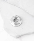 Premium Heavy Duty 4 Pack 5/16 24 Unf Stainless Steel Hex Flange Nut with flanged base on a white surface.