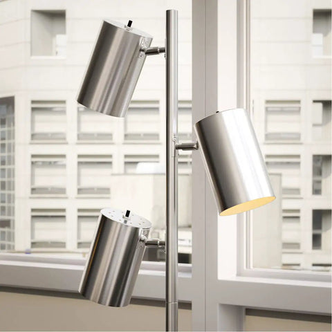 Ultra Tall Industrial Tree Floor Lamp With Three Adjustable Spotlights In Brushed Steel Finish, displayed near a window.