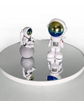 Ultimate 3 In 1 Motorized Rotating Display Stand With 360 Degree Electric Turntable And Swappable Covers For Professional Product Photography, Jewelry Shoots, Cake Presentations, And Live Videos In Sleek Black showcasing astronaut figurines on a reflective turntable.