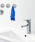 No Drill Needed Heavy Duty Stainless Steel Wall Hooks 6 Pack Adhesive Coat Hanger Set For Bathroom And Hallway holding a blue towel.