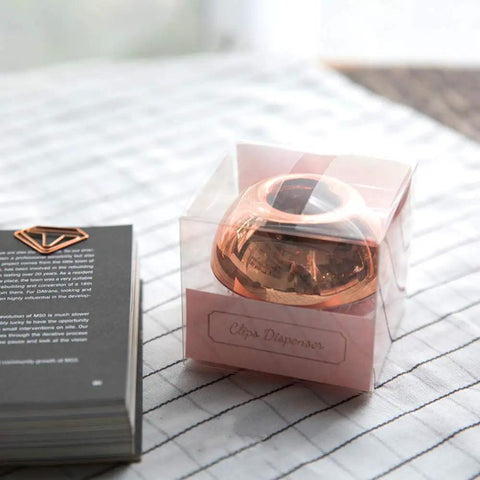 Magnetic Rose Gold Paper Clip Holder Dispenser With 100 Paper Clips in box, apple shape design, on checkered fabric surface
