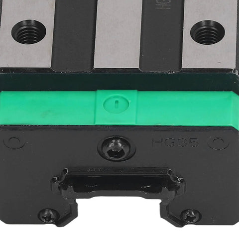 Close-up of a high precision linear motion rail bearing block with green and black casing for 3D printer builds.