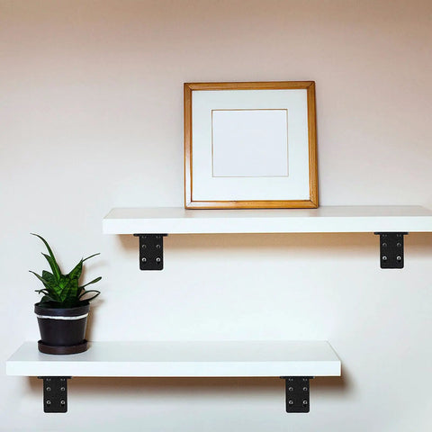 Tough As Nails 2 Pack Triangular Wall Shelf Brackets L Shaped Heavy Duty Corner Supports With Zero Wobble Guarantee For Floating Cabinets Up To 882 Lbs Capacity 320 X 100 Mm supporting white shelves with plant and picture.