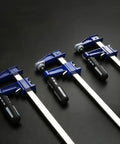 Professional Grade Eighteen Inch F Clamp Boasts A Smooth Quick Release Lever, four clamps lined up on a dark surface.
