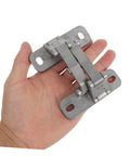 Heavy-duty stainless steel concealed hinge held in hand; dual mounting plates with screw holes