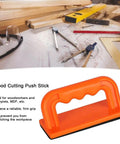 Safety Orange Oblique Push Block For Table Saws And Router Tables Featuring Steady Grip And Non Slip Base on woodwork desk.