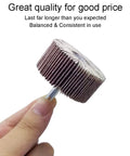 Hand holding a single flap wheel from Flap Wheels Set Of Twelve, Two Inch By One Inch By Quarter Inch, Aluminum Oxide, Pro Grade For Rust Removal And Weld Burrs, Three Of Each Grit Forty Sixty Eighty One Twenty, Quarter Inch Shank Fits All Drills, showing its compact size and sturdy design.