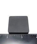 One And A Half Inch Square Silicone Rubber Stick On Feet Bumpers Three Sixteenths Inch Thick Adhesive Pads shown with ruler