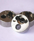 Front view of three 7/8-inch stainless steel poppet housing parts for water jet pump.