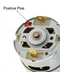 Close-up view of RS550 10.8V DC motor showing terminal configuration and positive pole marking.