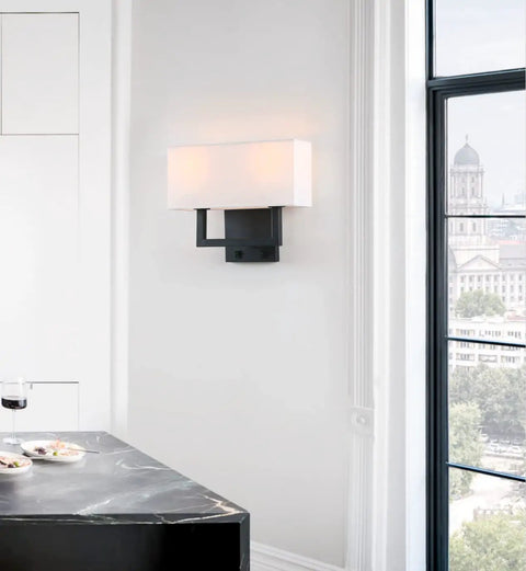 Double Black Wall Sconce Set With White Textile Shades And Easy On Off Switch Modern Living Room Bedroom Bedside Lighting Fixture For Cozy Vibe Lighting Works With E26 Bulbs And Dimmable Options mounted on a white wall next to a window.