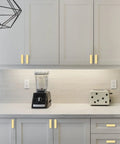 Modern kitchen with Ten Pack Brushed Gold Cabinet Knobs 2 Inch 50mm Single Hole Pulls installed on white cabinets and drawers ZH0026.