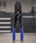 Professional Heavy Duty Manual Terminal Crimping Tool Pliers With Ergonomic Blue Grip shown on workbench with high carbon steel finish.