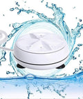 Portable Mini Washing Machine With Real Ultrasonic Power Foldable 3 In 1 Compact Setup For Travel And Small Spaces on water surface.