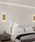 ZEROUNO Modern LED Wall Sconce Indoor Wall Lights Set of 2, Bronze Hardwired mounted beside a bed in a cozy bedroom.