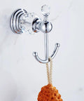 Crystal Chrome Bathroom Accessory Set For Your Modern Pad with polished silver coat hook mounted on wall