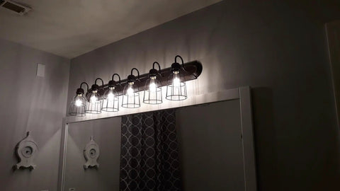 Premium Black Metal Wire Cage Lamp Guard For Ceiling Fans And Pendant Lights Killer Diamond Shape Light Cover With Slick Rust Resistant Coating Set Of Two over a bathroom mirror.