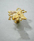 Elevate Your Vibe With These Charming Bee Cabinet Knobs Set Of 8 Golden Drawer Pulls For Dressers And Wardrobes Heavy Duty Zinc Alloy Bedroom Furniture Handles Screws Included, close-up of golden bee cabinet knob.