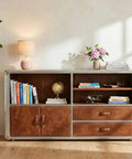 Knockout Aviator Sideboard Cabinet Drops That Aero Industrial Heat With Wraparound Weathered Brown Leather Riveted Silver Trim And Massive Storage Building A Solid 54 Inch Credenza Console Table For Any Cool Living Space in a cozy setting with books and decor.