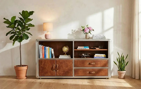Knockout Aviator Sideboard Cabinet Drops That Aero Industrial Heat With Wraparound Weathered Brown Leather Riveted Silver Trim And Massive Storage Building A Solid 54 Inch Credenza Console Table For Any Cool Living Space in a cozy setting with books and decor.