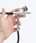 Badass Durable Nylon Airbrush Hose Spanning 1.8 Meters with Universal 1 8 Interface connected to an airbrush for smooth painting.