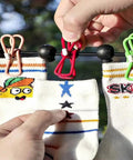 Retractable Portable Clothesline For Travel And Home with colorful clips holding socks outdoors