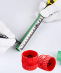 Two red plastic inner-outer pipe deburring reamer caps for PVC tubes; green pipe and measuring tape visible.